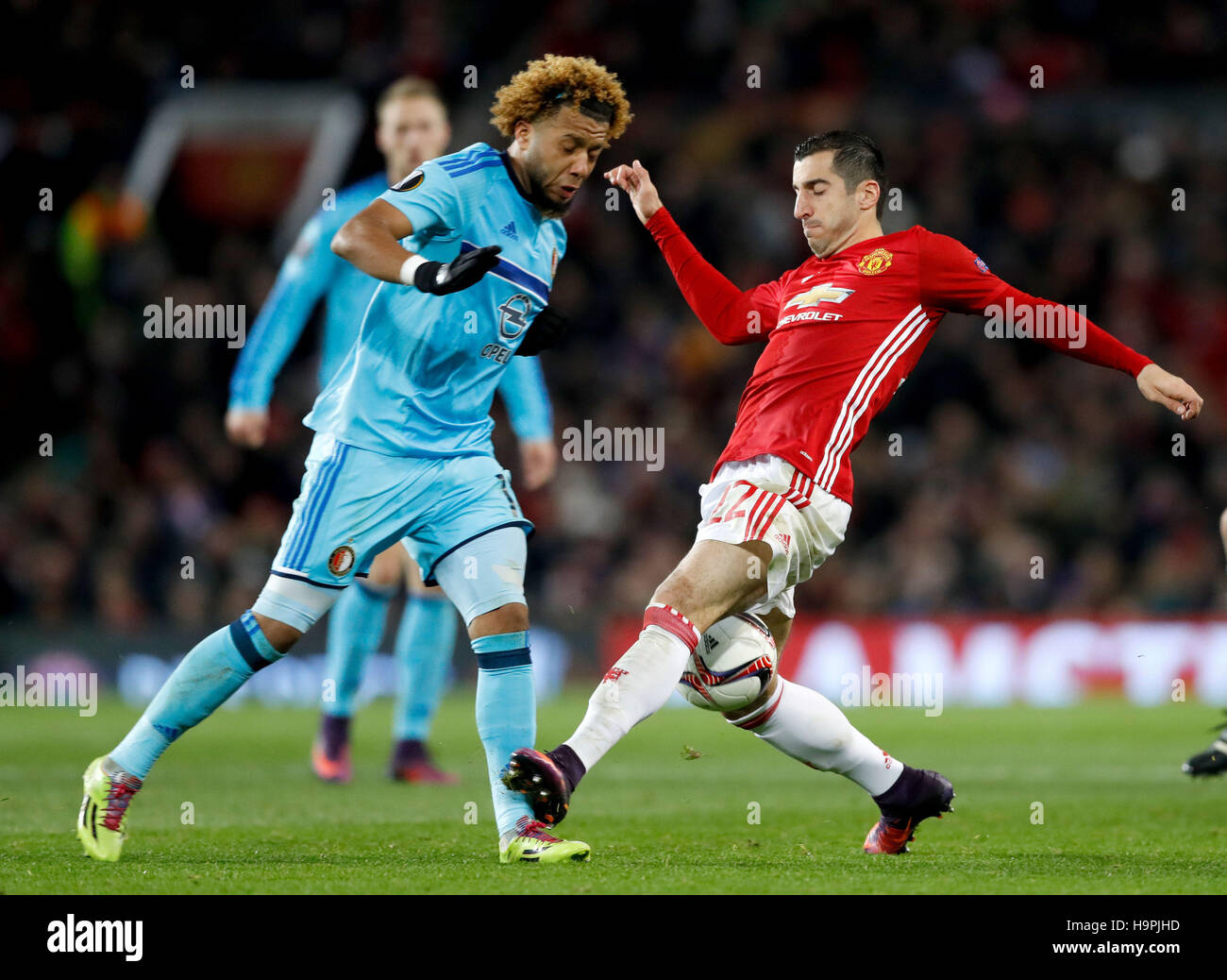 Manchester United's Henrikh Mkhitaryan (right) and Feyenoord's Renato Tapia (left) battle for the ball during the UEFA Europa League match at Old Trafford, Manchester. Stock Photo