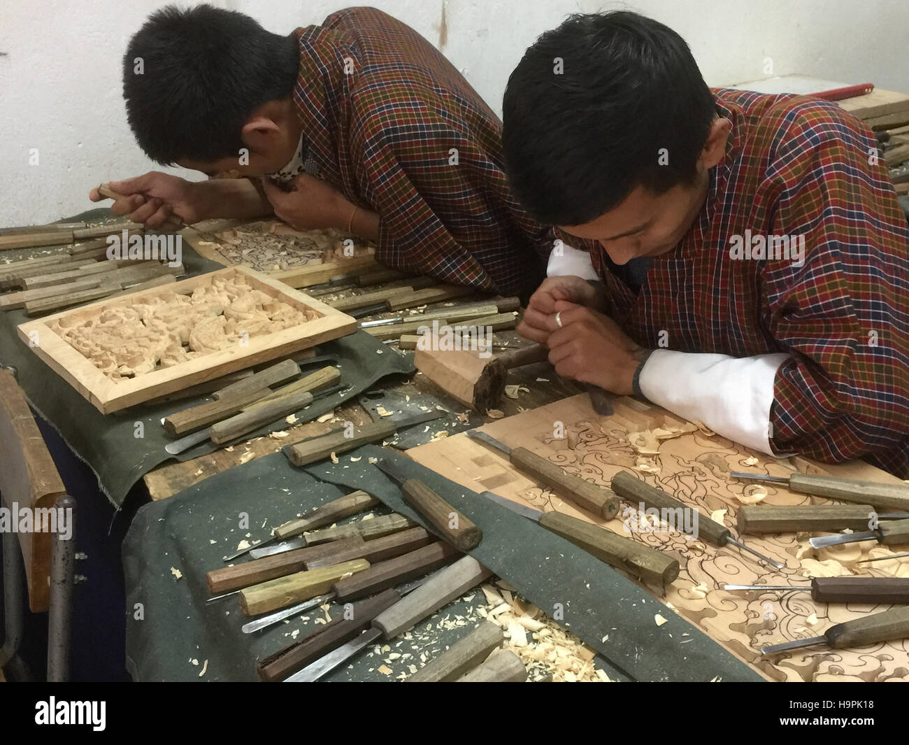 BHUTAN Thimphu. First year wood carving students at the Voluntary Artists Studio. Photo Tony Gale Stock Photo