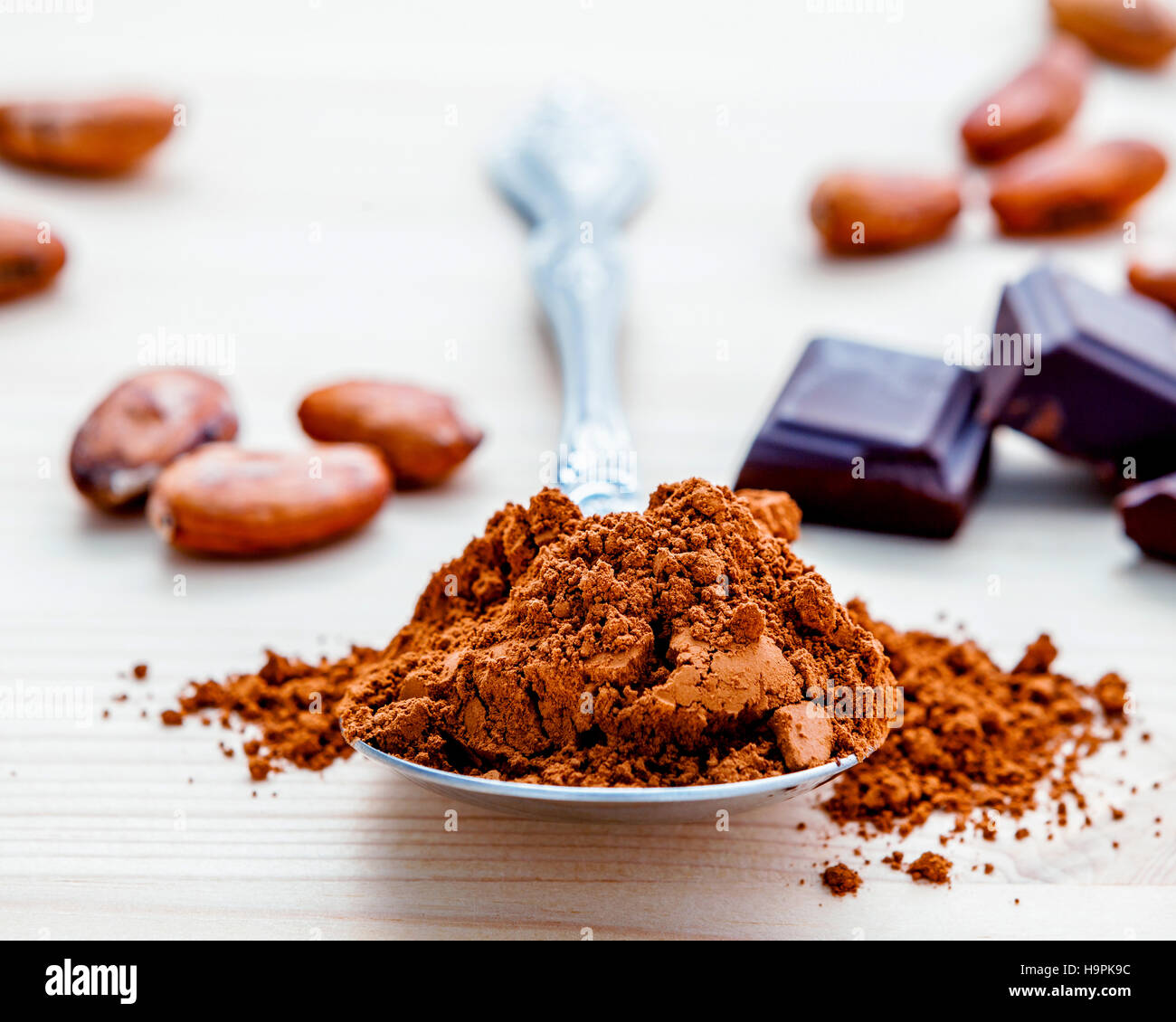 Brown chocolate powder in spoon , Roasted cocoa beans and dark c Stock Photo