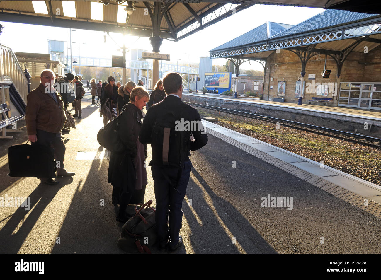 Passengers casting shadows on a railway platform, Perth,Scotland,UK Stock Photo