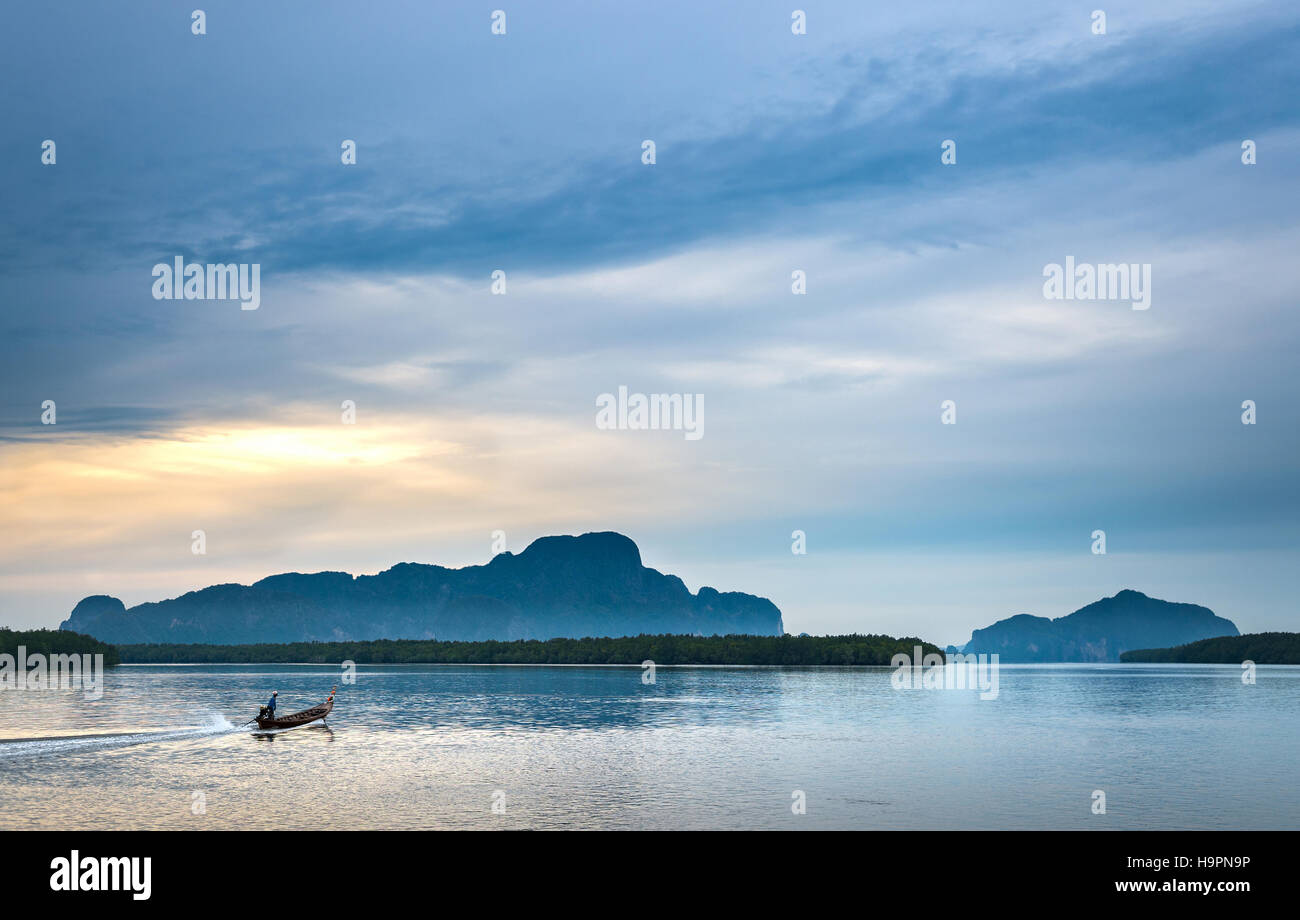 Fishermen out for fishing in every morning with longtail fishing boat at Samchong-Tai fishing village on sunrise in Phang-Nga, Thailand. Stock Photo