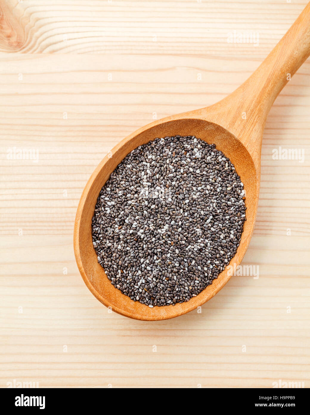 Nutritious chia seeds in wooden spoon for diet food ingredients Stock Photo