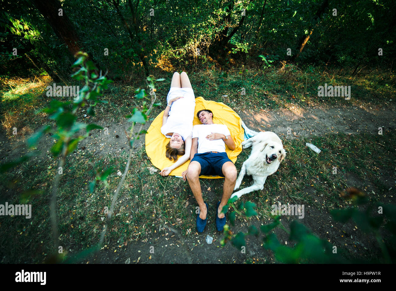 pregnant woman with husband lying in the park Stock Photo - Alamy