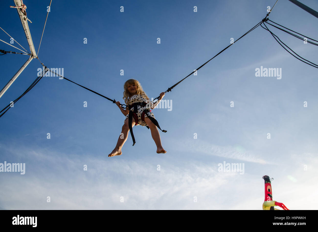 little girl jumping up into the skies Stock Photo - Alamy