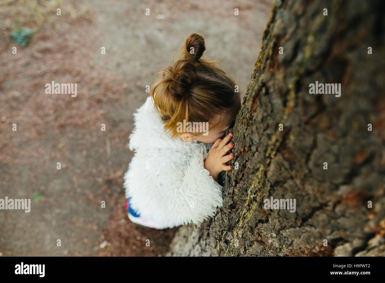 Cute little girl is playing outdoors Stock Photo - Alamy