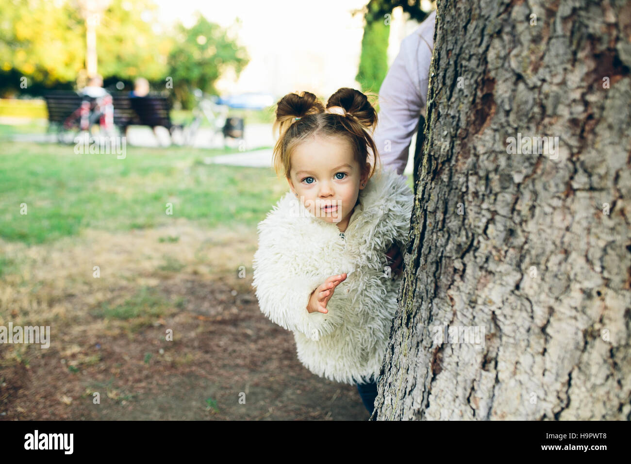 Cute little girl is playing outdoors Stock Photo - Alamy