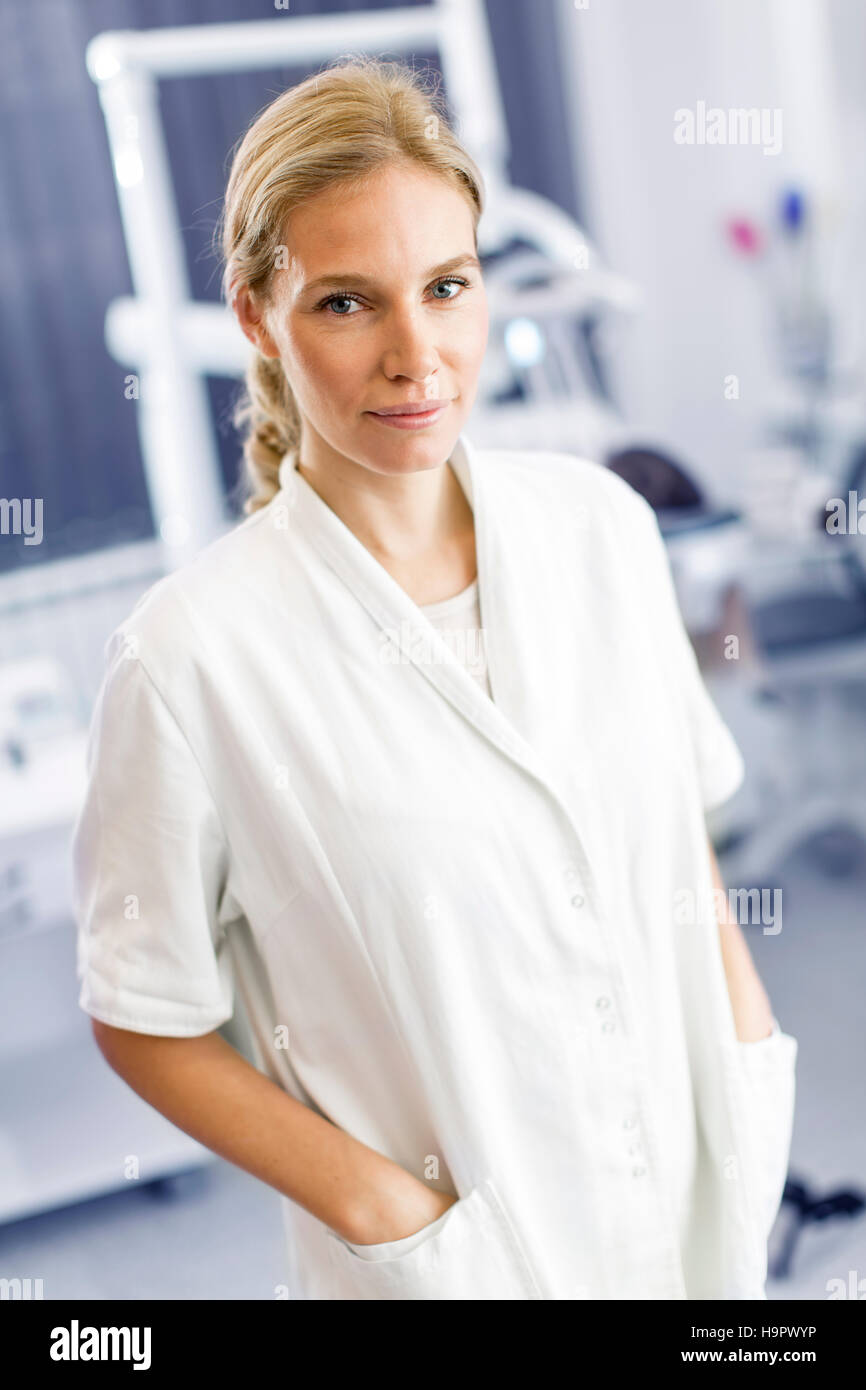 Attractive female dentist posing in modern dental office Stock Photo Alamy