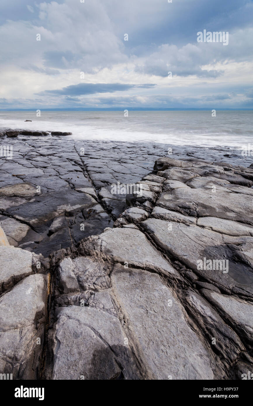 Stormy skies on the edge of Traeth Mawr on the Glamorgan Heritage Coastline in Wales. Stock Photo