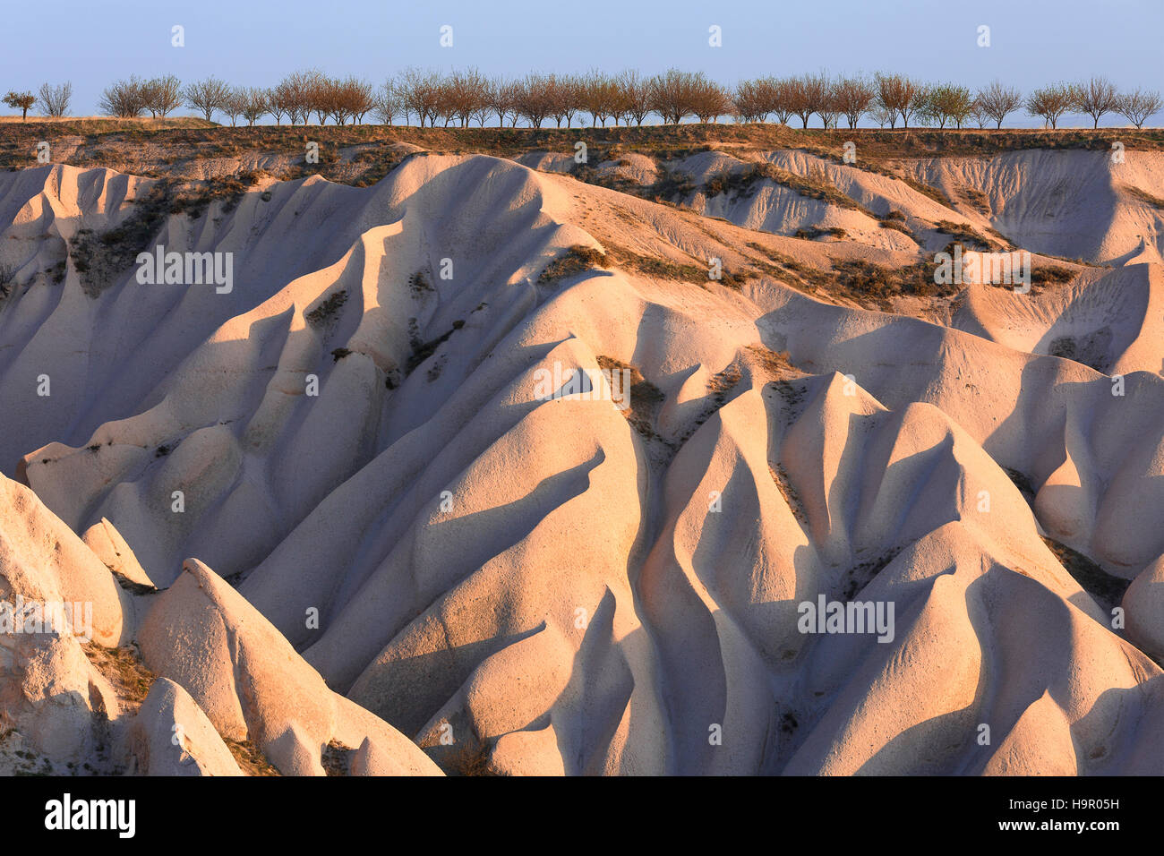Geological formations looking sand dunes in Cappadocia in Turkey Stock Photo