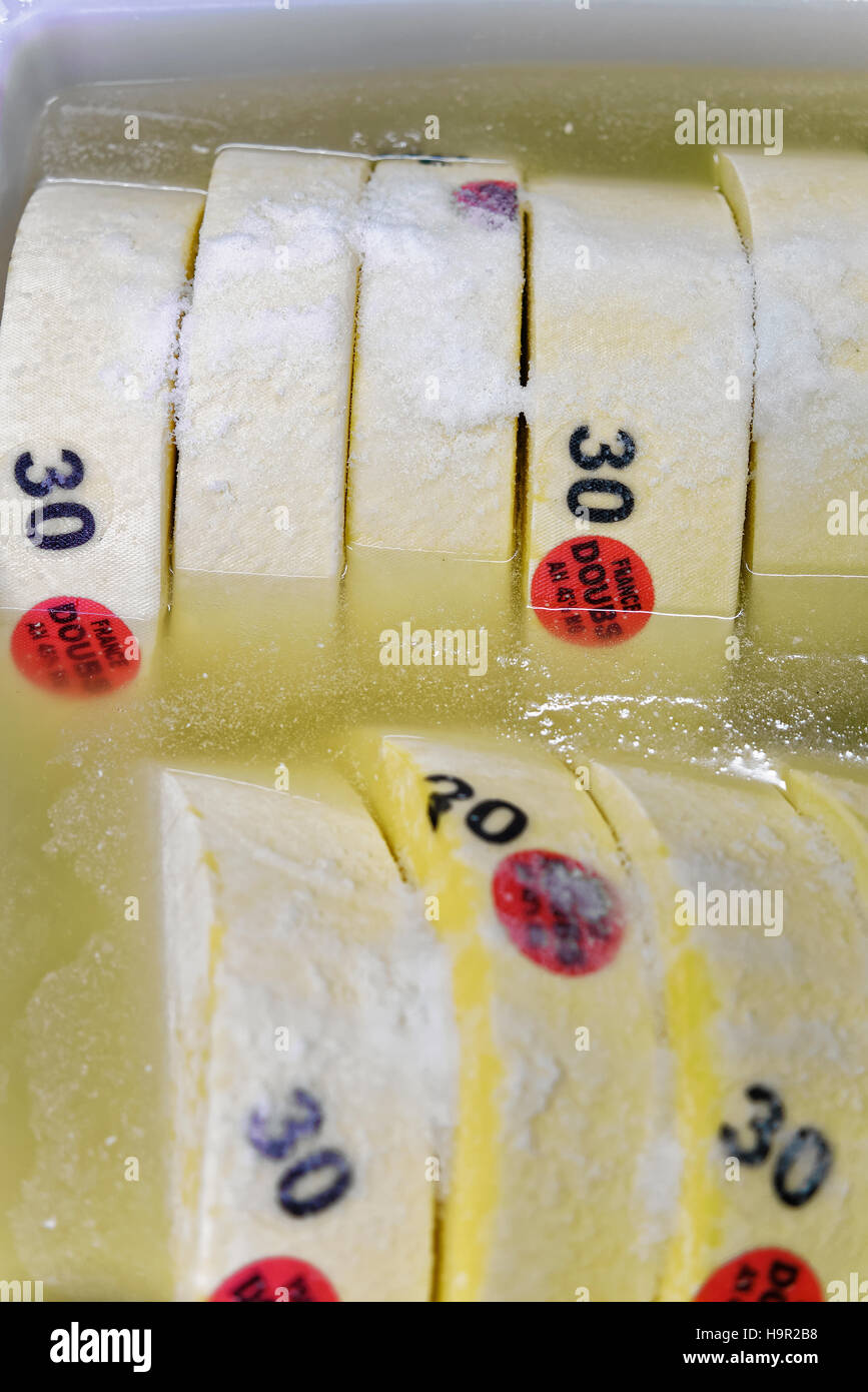 Gruyere de Comte Young Cheese in bath with salt, in Franche Comte dairy