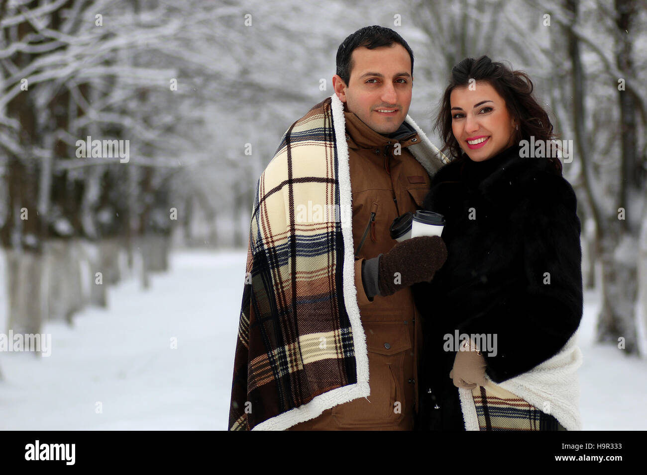 beautiful young couple in a snowy park Stock Photo - Alamy
