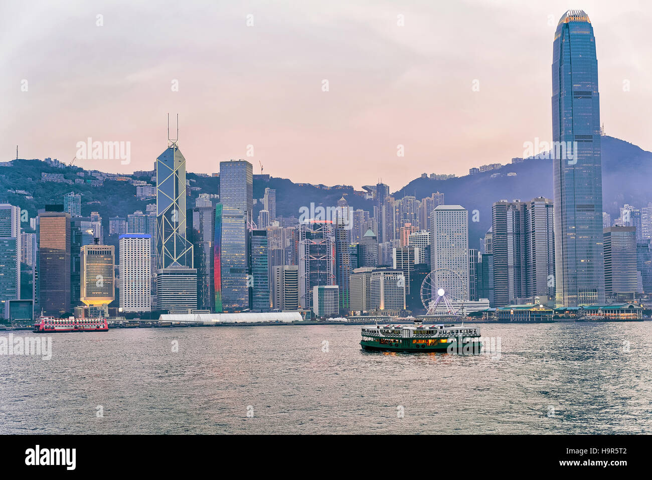 Star ferry and Victoria Harbor of Hong Kong. View from Kowloon on HK Island. Stock Photo