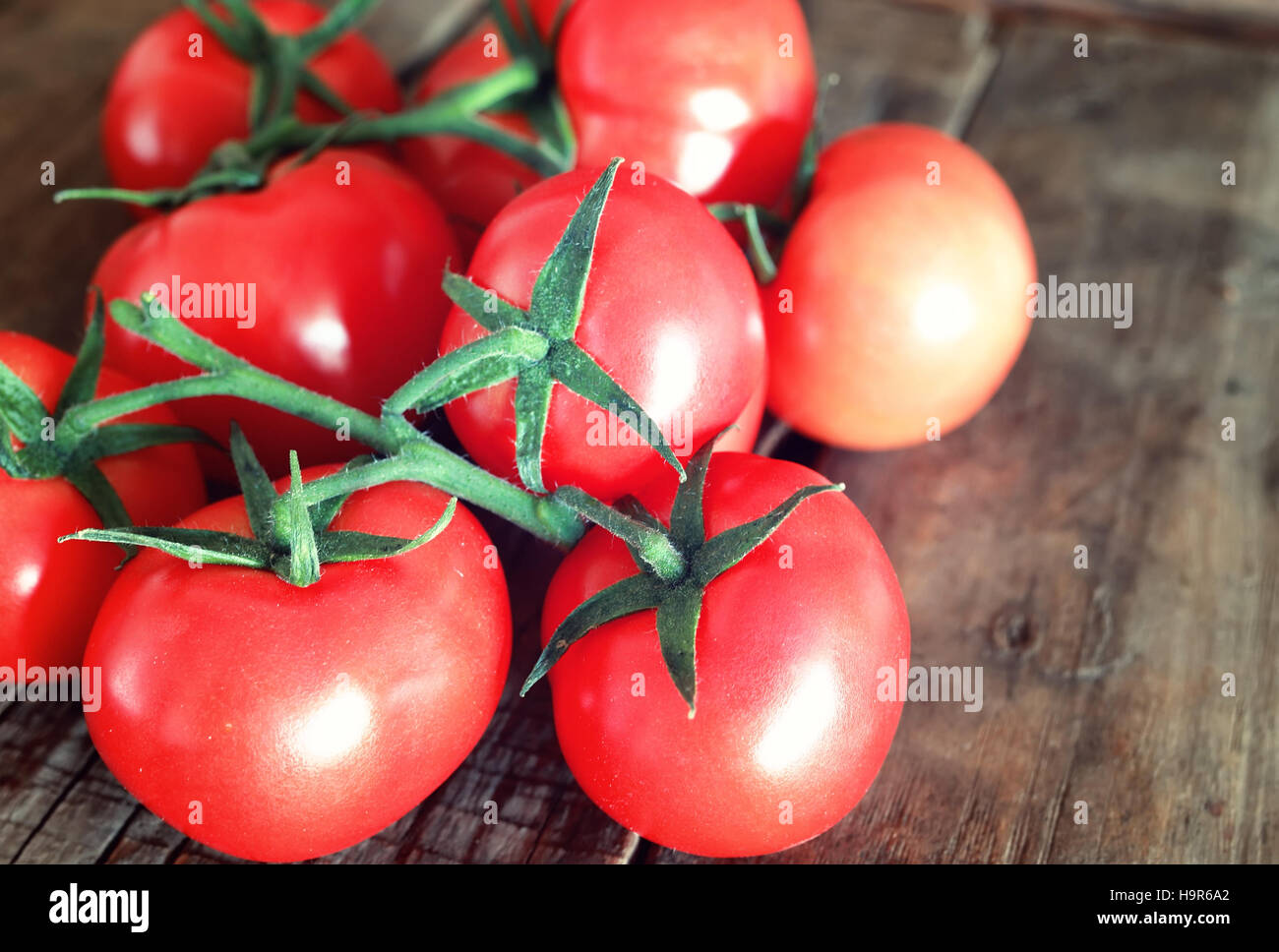 tomatoes on wooden background Stock Photo - Alamy