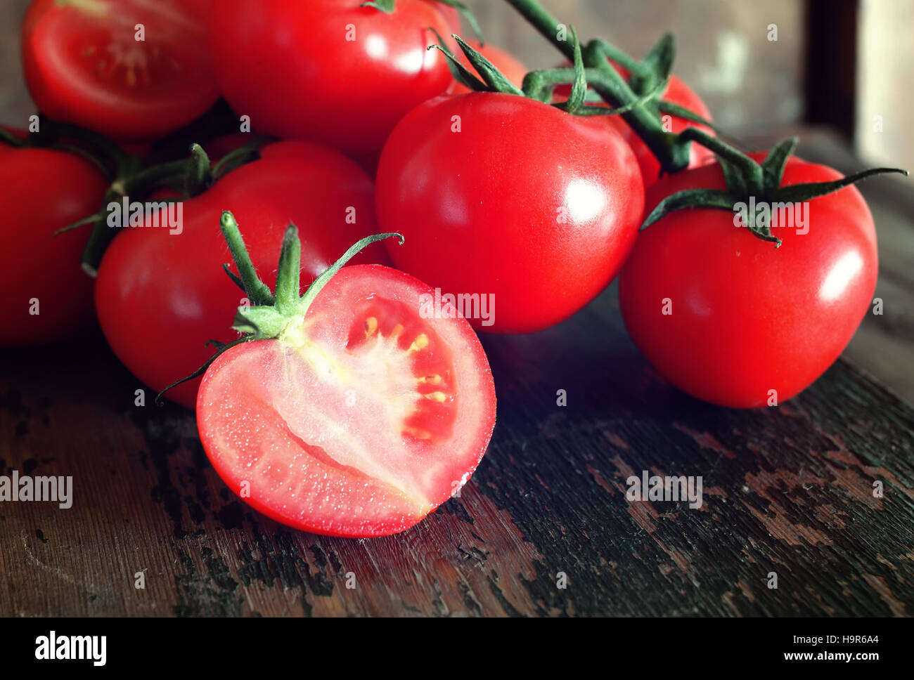 tomatoes on wooden background Stock Photo - Alamy