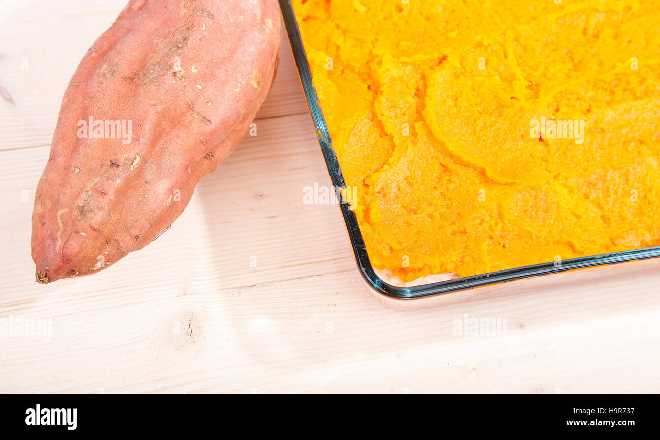 Oven meal with sauerkraut and sweet potato on wooden background Stock Photo