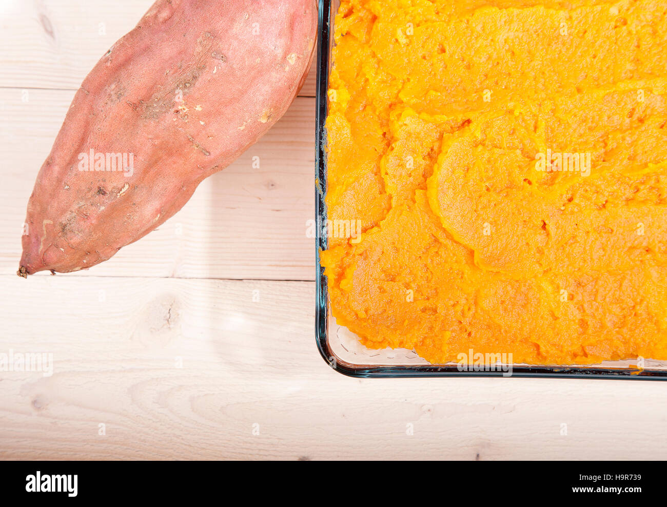 Oven meal with sauerkraut and sweet potato on wooden background Stock Photo