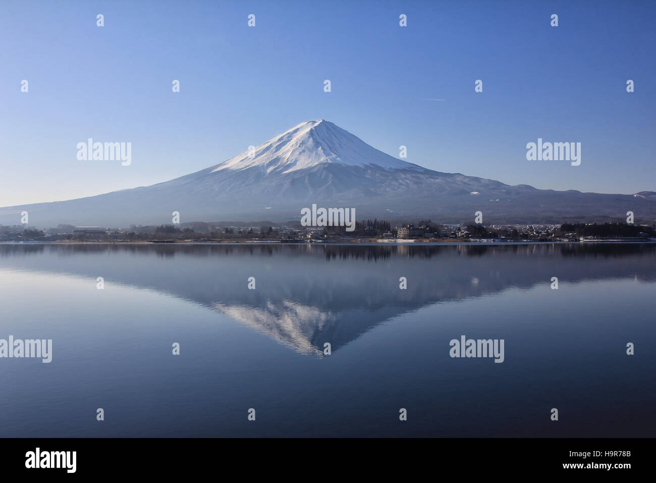 Mount Fuji mirror reflection view from the lake Kawaguchi in January 2015, Japan. The top of the mountain is covered with snow. Stock Photo