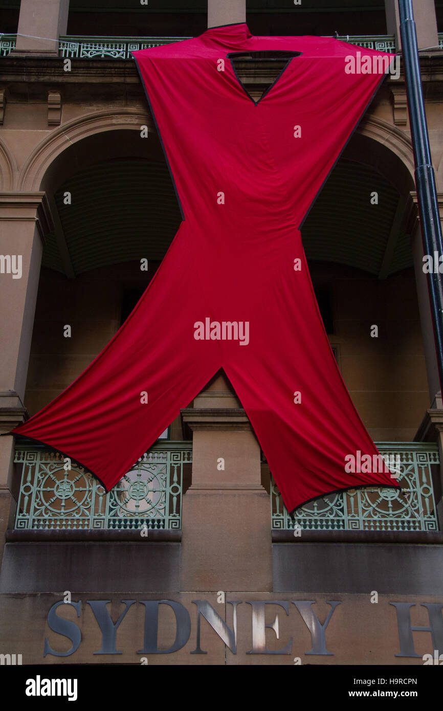 Sydney, Australia. 25 November 2016. A giant red ribbon can be seen on the Sydney Hospital building on Macquarie Street ahead of World AIDS Day on 1 December each year. World AIDS Day raises awareness around the world about the issues surrounding HIV and AIDS. It is a day for people to show their support for people living with HIV and to commemorate people who have died. Credit: Credit:  2016 Richard Milnes/Alamy Live News. Stock Photo