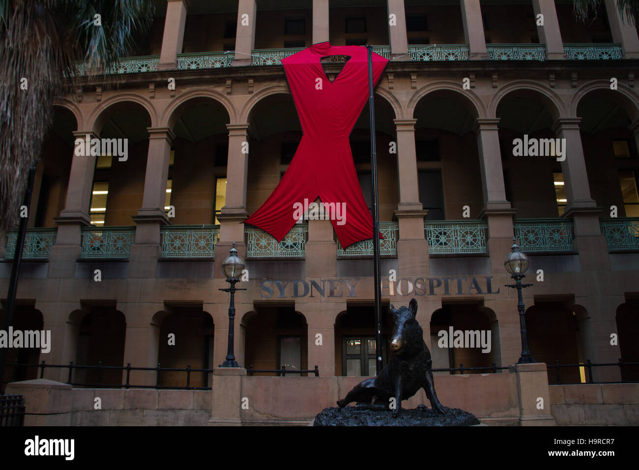 Sydney, Australia. 25 November 2016. A giant red ribbon can be seen on the Sydney Hospital building on Macquarie Street ahead of World AIDS Day on 1 December each year. World AIDS Day raises awareness around the world about the issues surrounding HIV and AIDS. It is a day for people to show their support for people living with HIV and to commemorate people who have died. Credit: Credit:  2016 Richard Milnes/Alamy Live News. Stock Photo