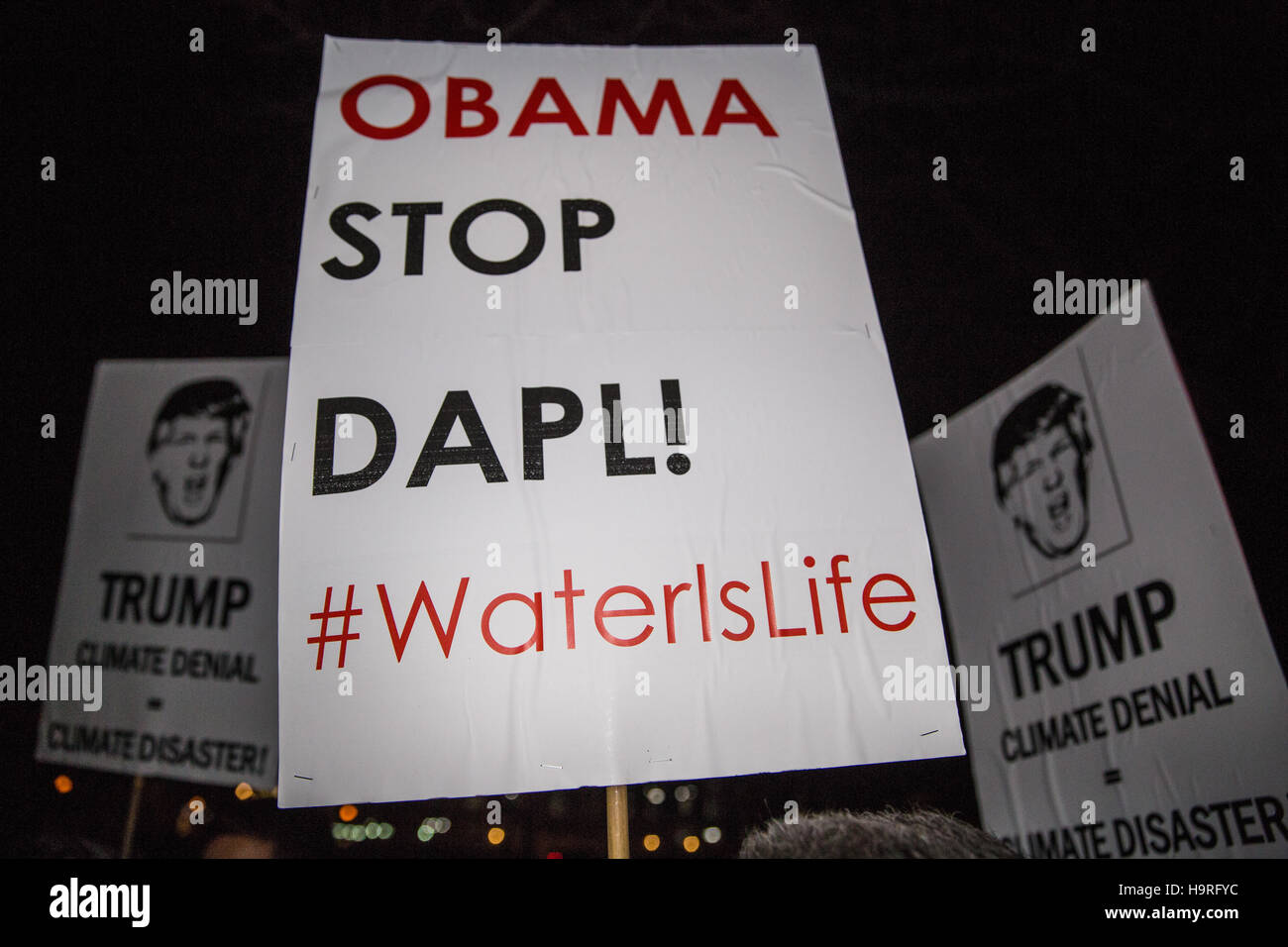London, UK. 25th November, 2016. Placards held by activists from the Campaign Against Climate Change protesting outside the US Embassy in solidarity with American climate activists preparing to campaign against President Elect Donald Trump and also in solidarity with those protesting at Standing Rock. Credit:  Mark Kerrison/Alamy Live News Stock Photo