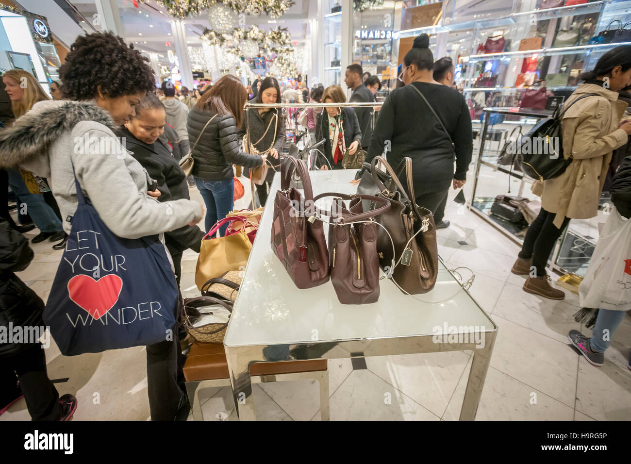 New York, USA. 25th November, 2016. Shoppers browse Michael Kors handbags  in the Macy's Herald Square flagship store in New York looking for bargains  on the day after Thanksgiving, Black Friday, November