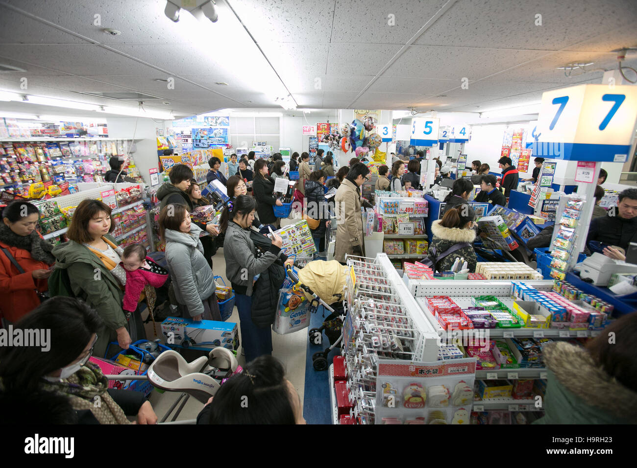 Customers wait in a checkout line on Black Friday at a Toys R Us