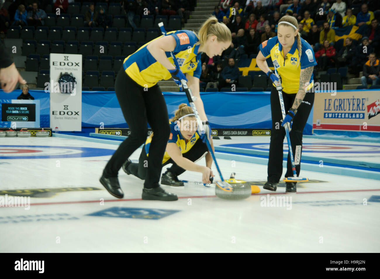Braehead Arena, Renfrewshire, Scotland, 26 November 2016. Agnes Knochenhauer of Sweden delivering a stone during their match against Russia in the final of the Le Gruyère AOP European Curling Championships 2016. It is being swept by Sara McManus and Sofia Mabergs.  Credit:  Colin Edwards / Alamy Live News Stock Photo