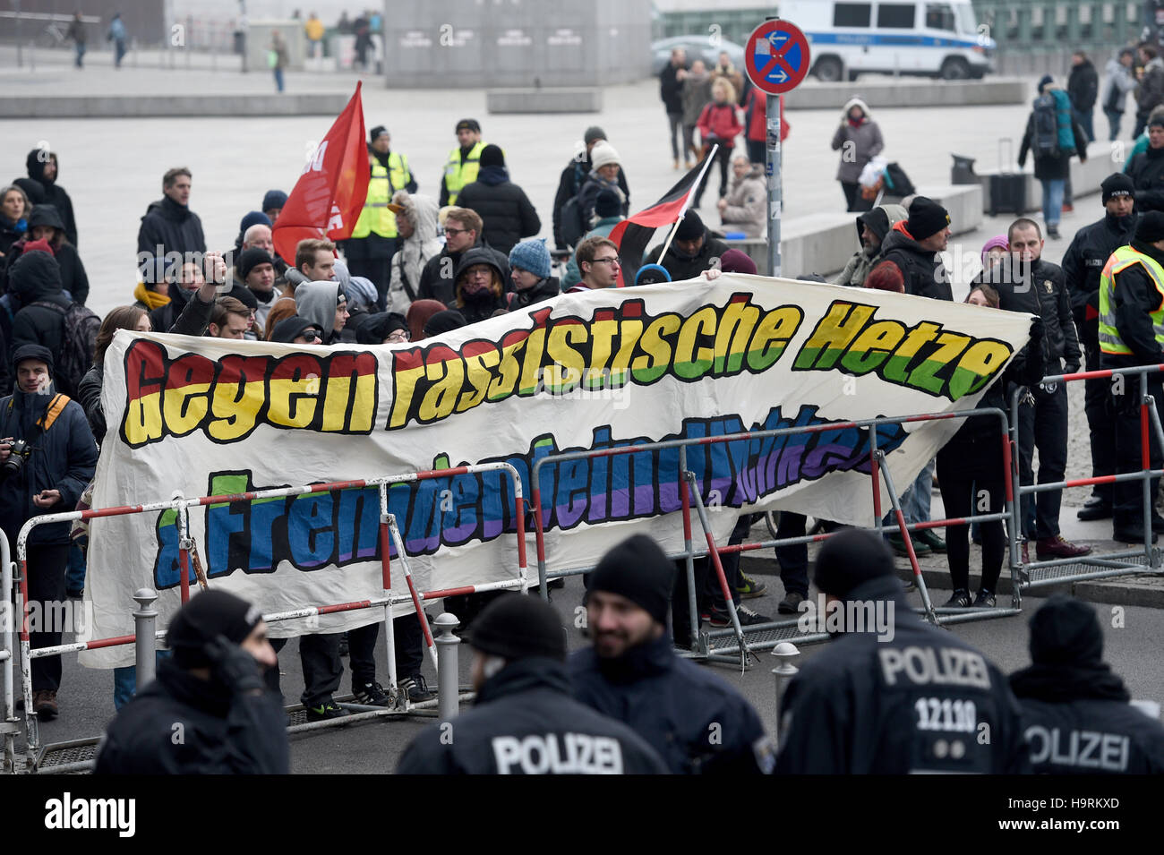 Berlin, Germany. 26th Nov, 2016. Counter demonstrators protesting a demo by the Berlin offshoot of the Pegida movement 'Baergida' in Berlin, Germany, 26 November 2016. The Bundestag is just visible in the background. Photo: Rainer Jensen/dpa/Alamy Live News Stock Photo