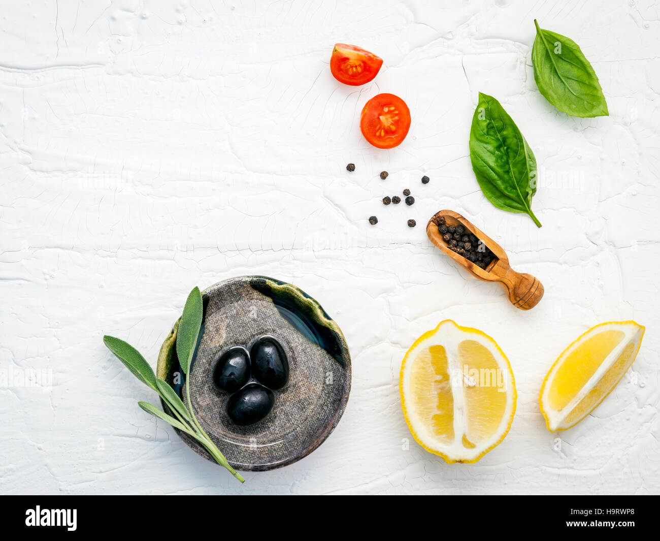 Food background with fresh herbs  tomato ,lemon slice , black pe Stock Photo