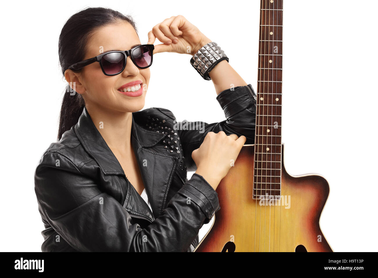 Portrait of a young woman posing with an acoustic guitar isolated on ...