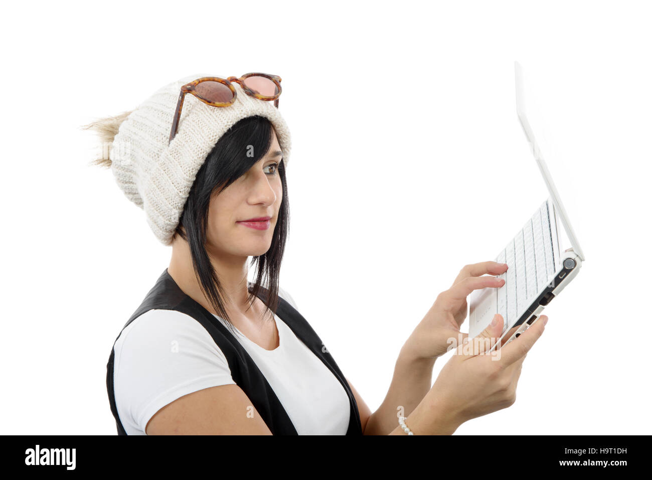 young brunette girl with a laptop isolated on white background Stock ...
