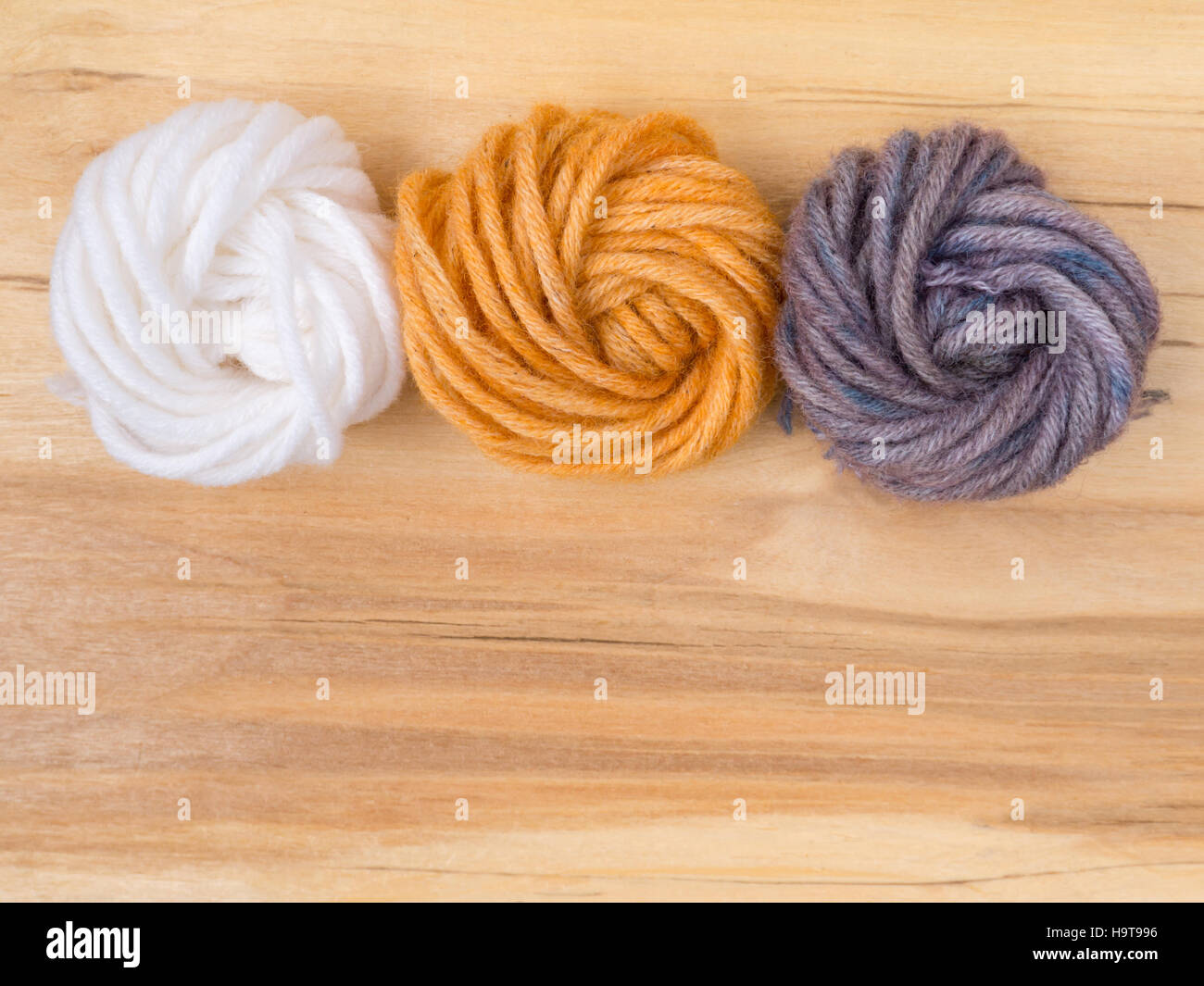 Wool bun swatches colored by henna and indigo and control white sample Stock Photo