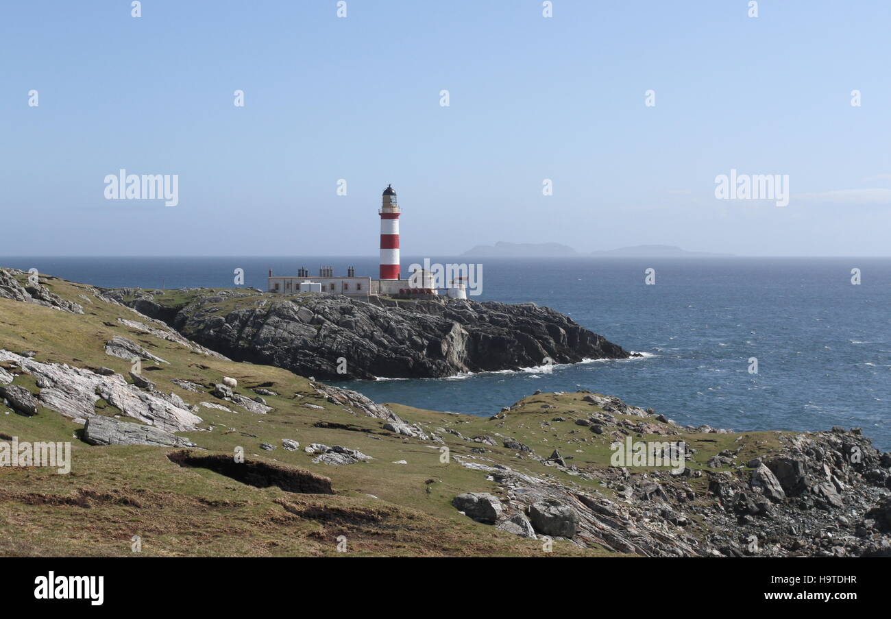 Eilean Glas lighthouse on Isle of Scalpay with distant Shiant Islands Scotland  May 2014 Stock Photo