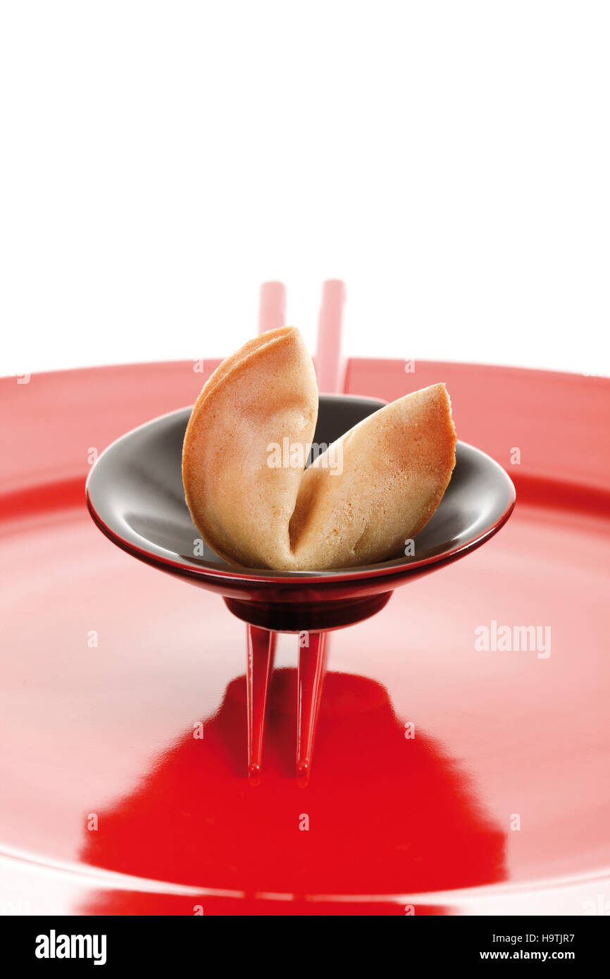 Fortune cookies with chopsticks on a red plate Stock Photo