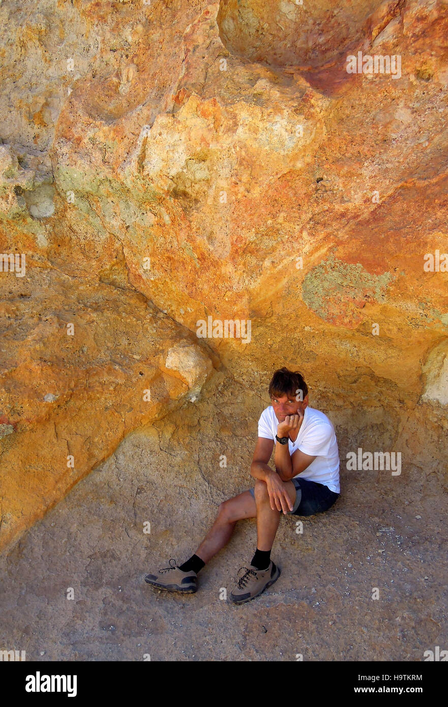 Man sits thoughtfully in Montaña Amarilla, Teide National Park, Tenerife, Canary Islands, Spain Stock Photo