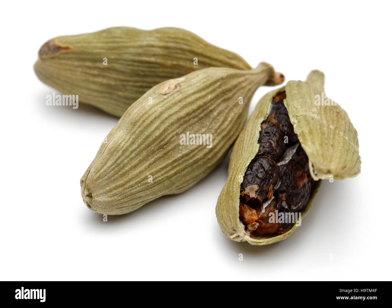 Green cardamom pods and seeds close up on white background Stock Photo