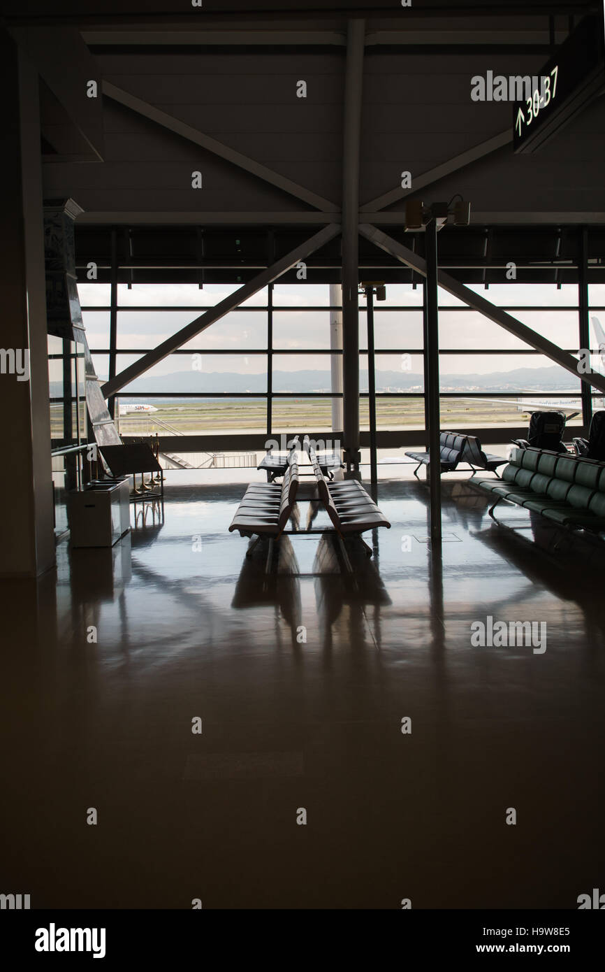 Empty Bench at waiting / departure gate area in the airport Stock Photo