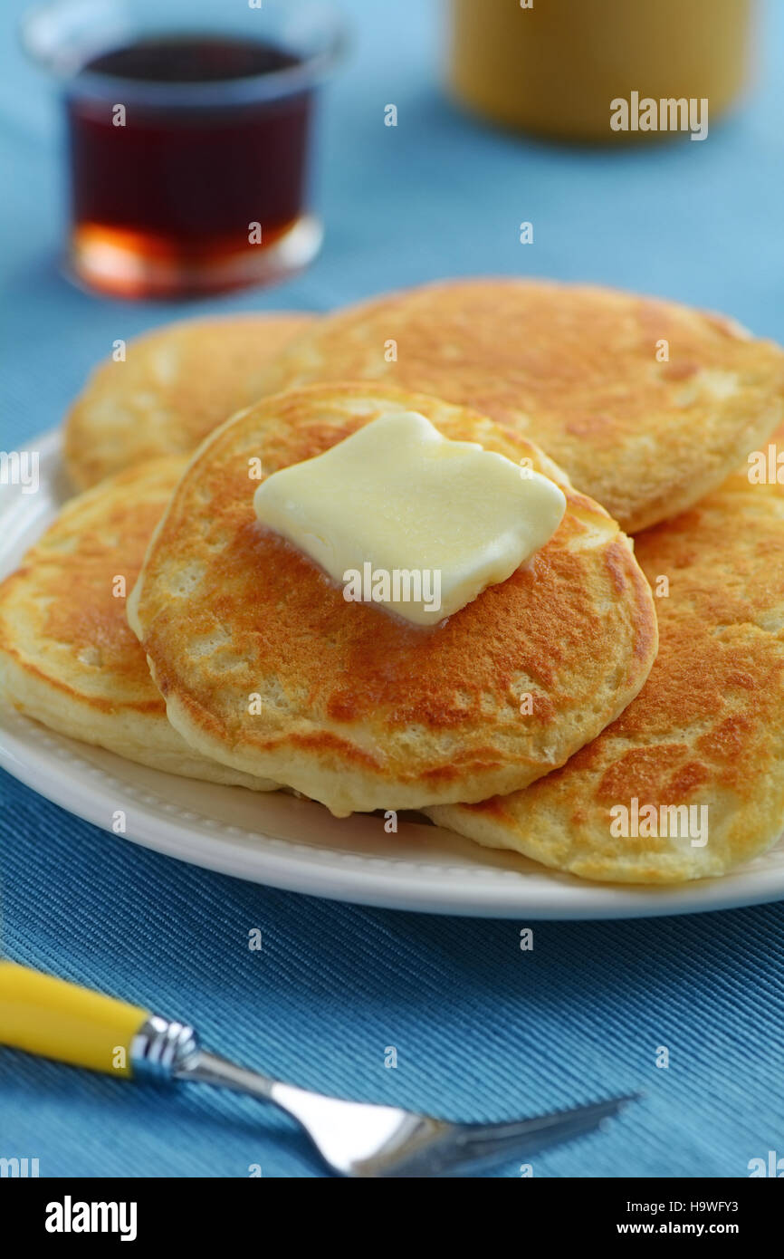 Fresh home made buttermilk pancakes with maple syrup shot in natural light Stock Photo