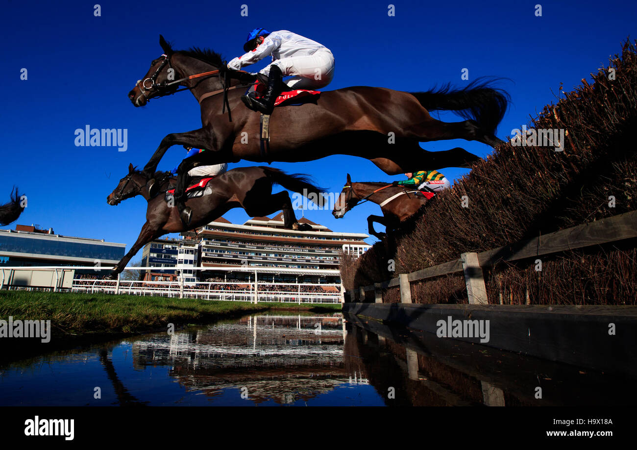 the eventual winner of The Fuller's London Pride Novices' Chase (Grade 2) (Registered As The Berkshire Novices' Chase) Clan Des Obeaux (white) ridden by Sean Bowen jumps the water jump during The bet365 Festival at Newbury Racecourse. Stock Photo
