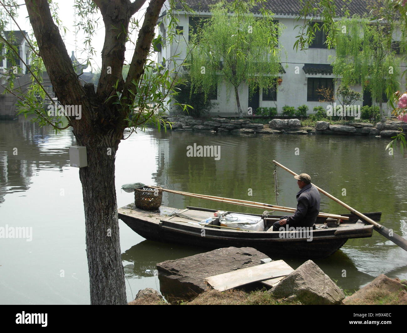 Boatman on his boat in Xitang water town, Zhejiang province, China Stock Photo