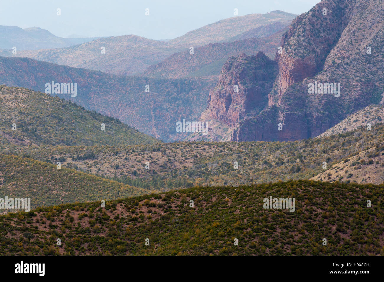 A large rocky outcropping in the Mazatzal Mountains above high desert mountains and hills. Mazatzal Wilderness, Arizona Stock Photo