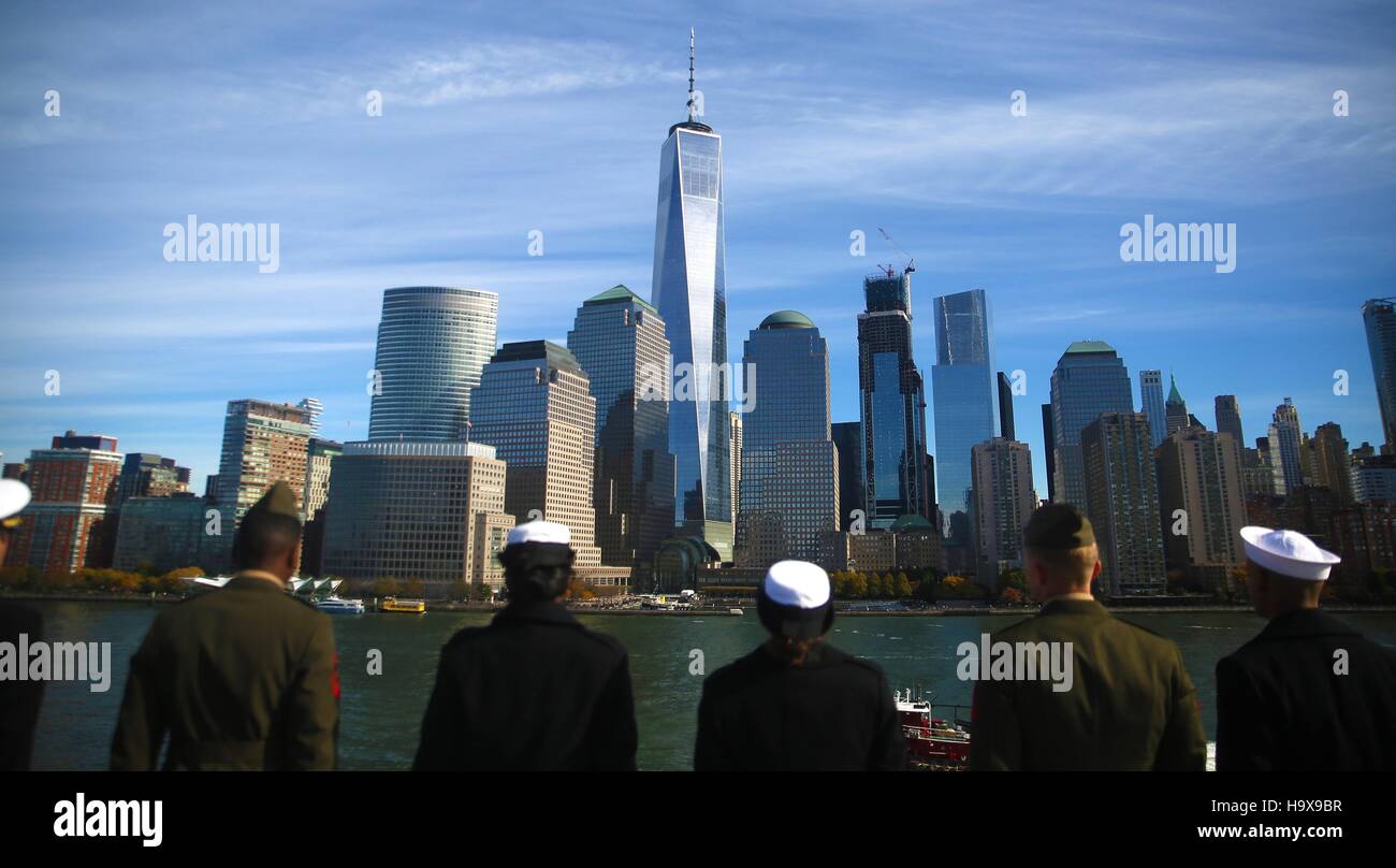 U.S. sailors aboard the USN Wasp-class amphibious assault ship USS Iwo Jima look at the Manhattan city skyline as they man the rails while entering the New York Harbor for Veterans Week November 10, 2016 in New York City, New York. Stock Photo