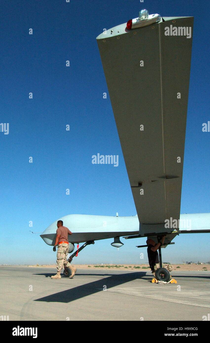 U.S. soldiers conduct pre-flight inspections on an RQ-1 Predator unmanned aerial vehicle before a flight mission for Operation Iraqi Freedom at the Balad Air Base September 15, 2004 in Yathrib, Iraq. Stock Photo