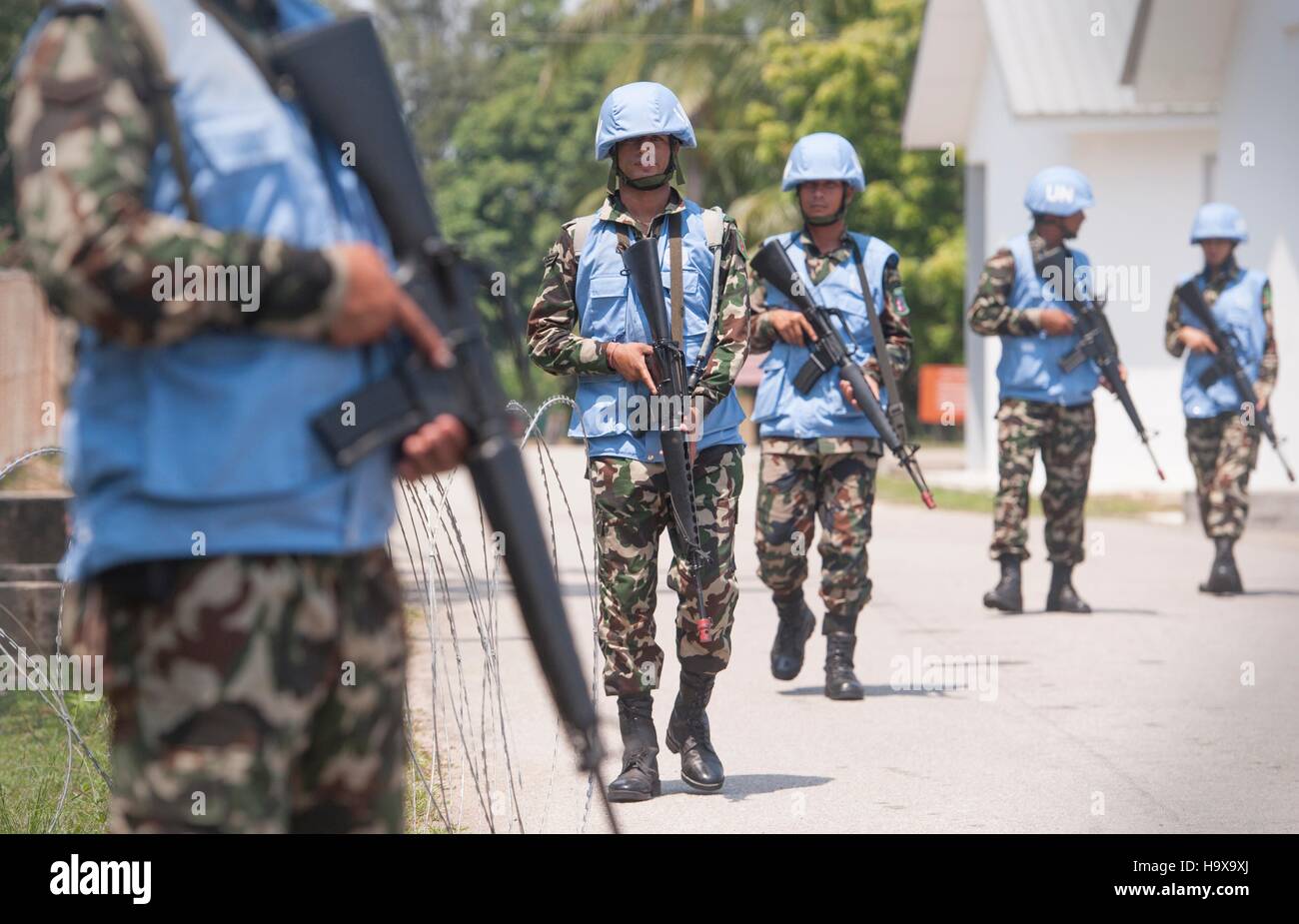 Nepalese soldiers provide security during peacekeeping training at a simulated UN site during Exercise Keris Aman at Segenting Camp August 15, 2015 in Port Dickson, Malaysia. Stock Photo