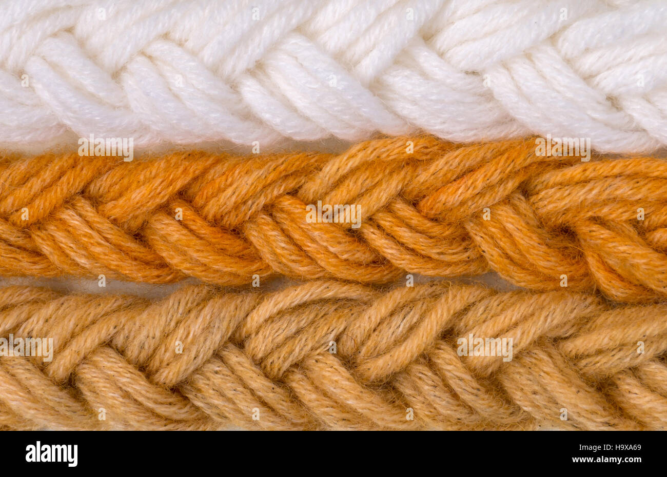 Braided wool yarn swatches colored by henna and henna and amalaki mix and control white sample Stock Photo