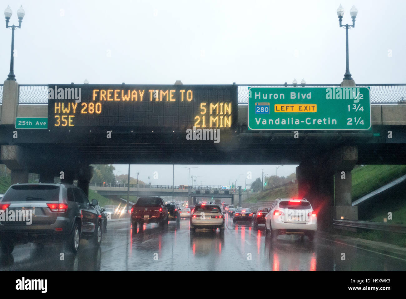 A wet travel down Freeway 94 with an electronic sign indicating the upcoming Highway 280. St Paul Minnesota MN USA Stock Photo