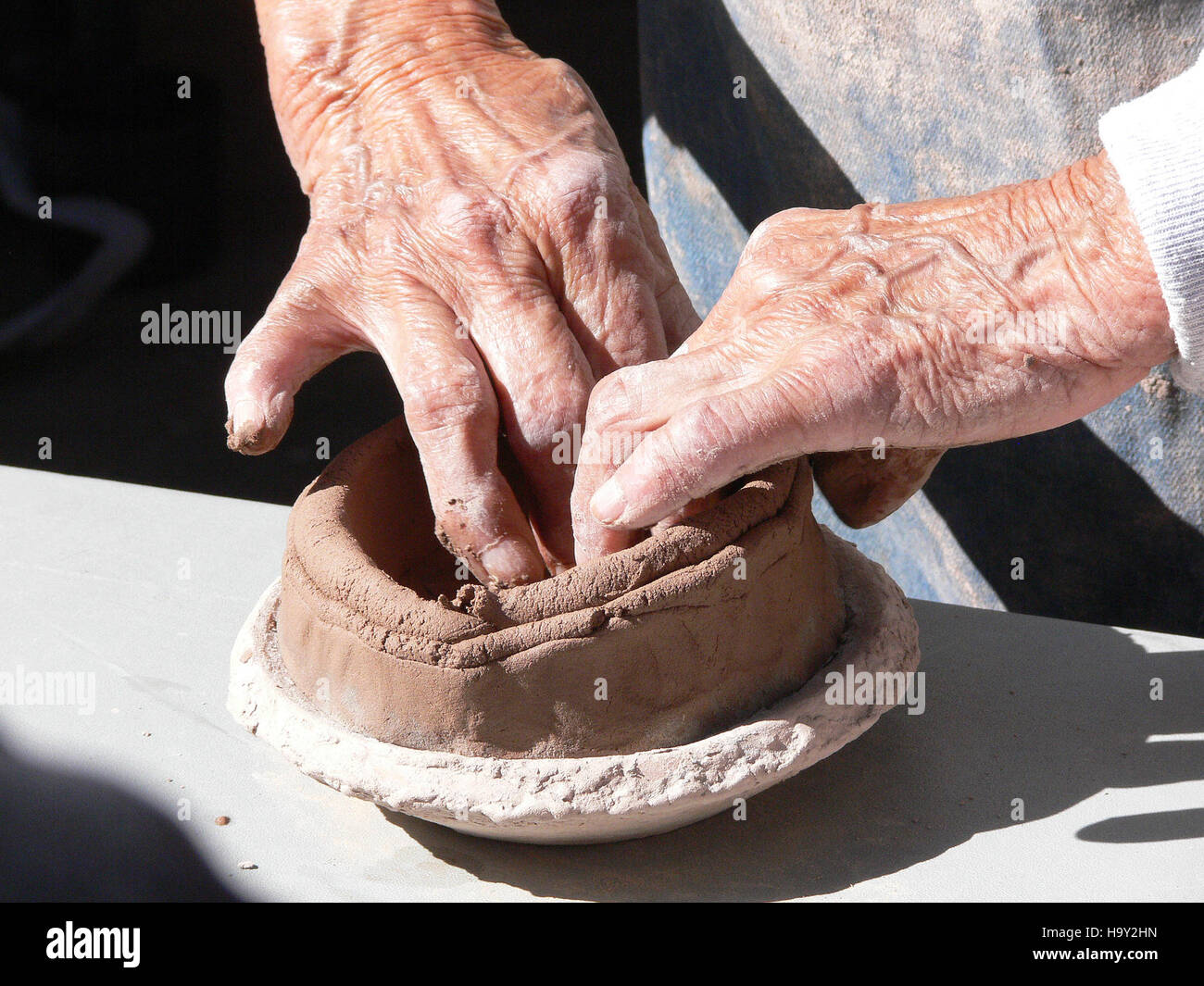 Bandelier National Park offers a hands-on pottery-making experience, highlighting the rich cultural history of the Ancestral Puebloans. Visitors can engage in crafting pottery while learning about the traditional methods and techniques used by the early inhabitants of the park. Stock Photo