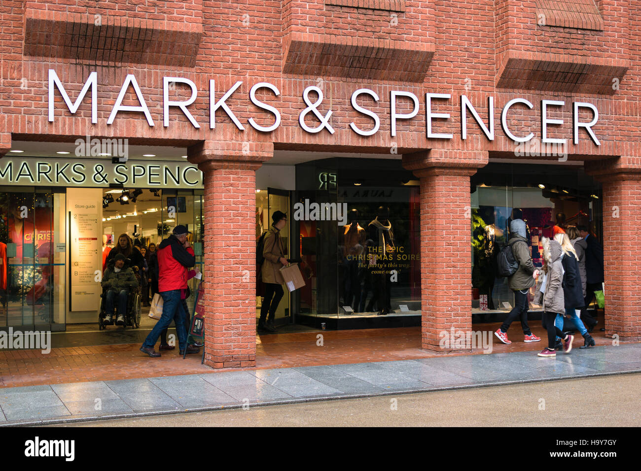 Exeter, England, UK - 22 November 2016: Unidentified people walk by Marks & Spencer store on High Street Stock Photo