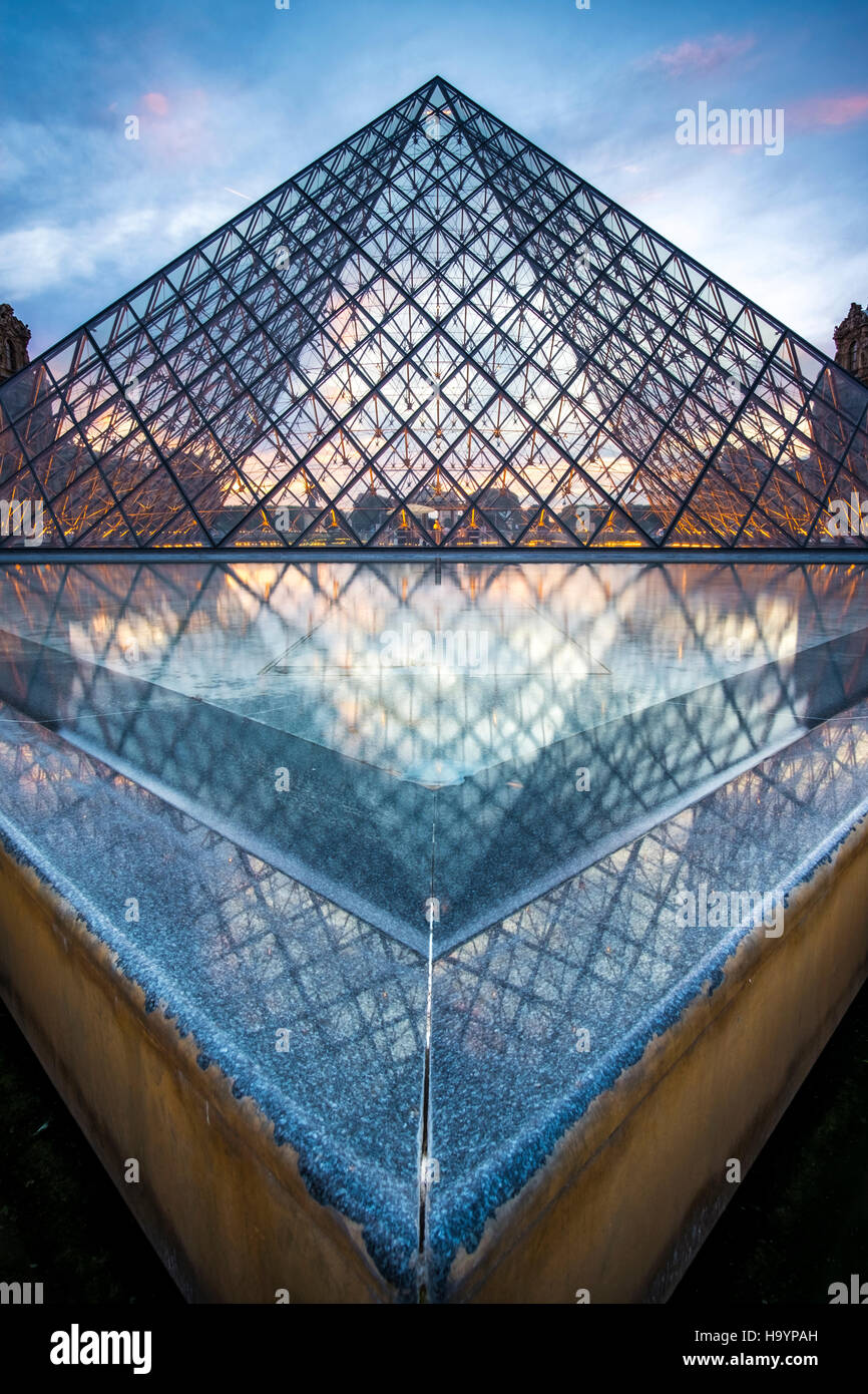 The glass pyramid entrance to the Louvre, designed by architect I.M.Pei. Evening shot in summer. Stock Photo