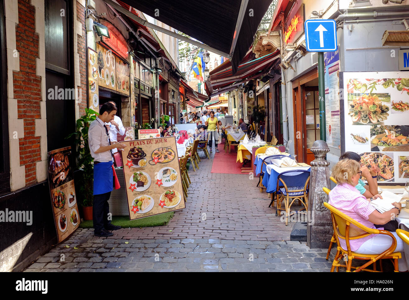 Narrow street full of restaurants, Brussels, Belgium Stock Photo